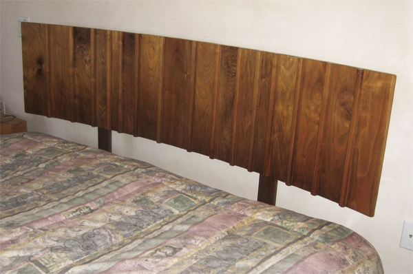 Walnut headboard for king size bed with random width boards and raised dividers