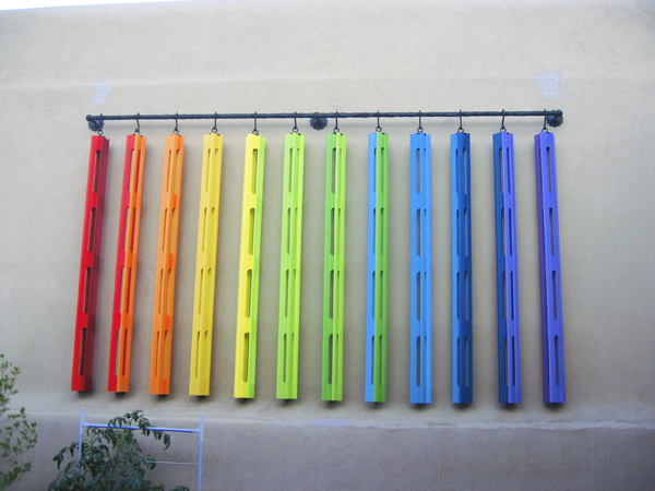 Wooden Wind Spinners installed on patio wall 